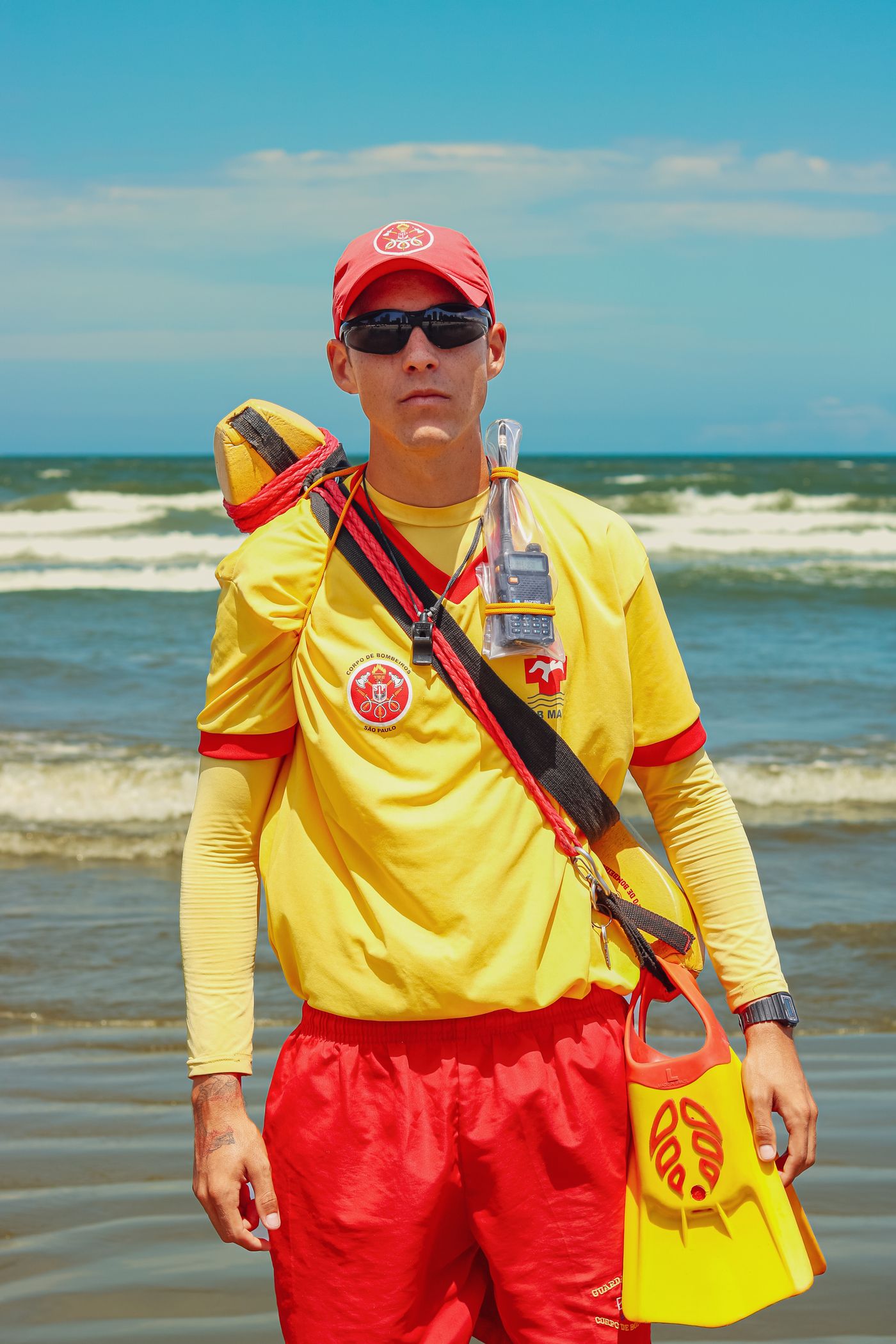 Beach lifeguard carrying professional rescue equipment
