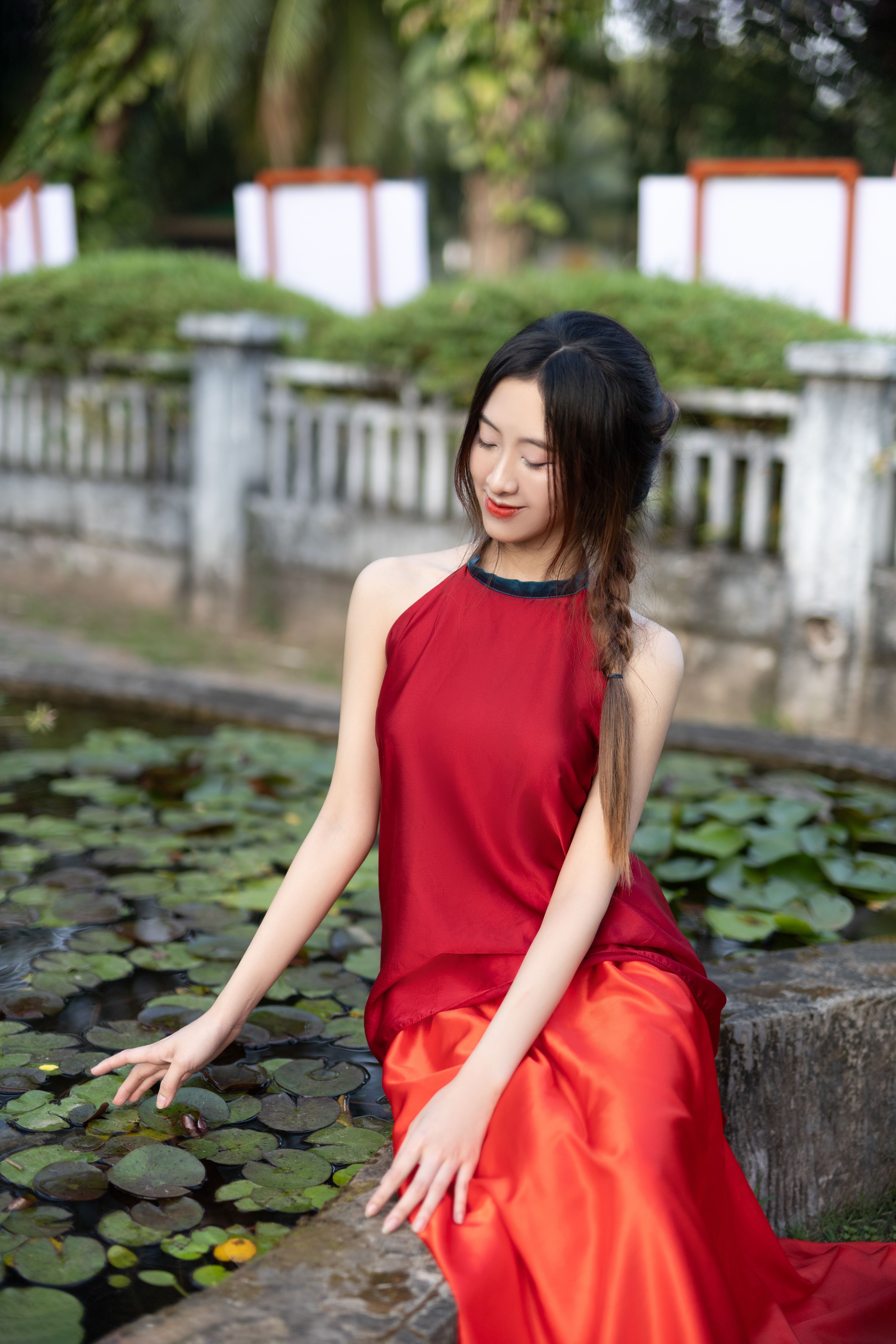 Elegant Woman in Red Dress by Water Lilies · Free Stock Photo