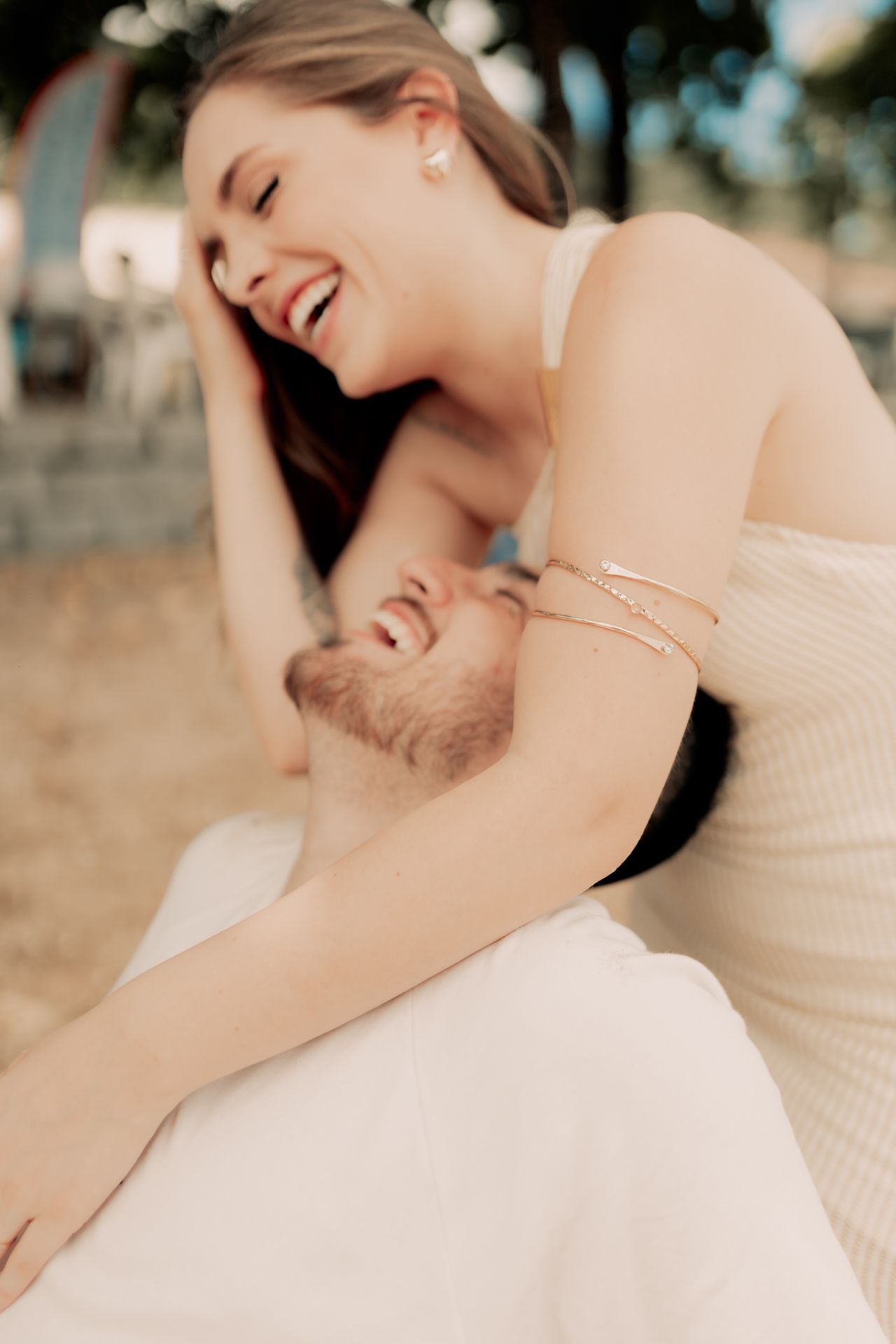Happy young couple laughing and embracing outdoors
