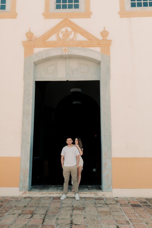 Free A young couple standing at the entrance of a historic building with ornate architecture. Stock Photo