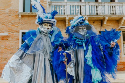 Free Elegant blue and silver costumes at Venice Carnival, featuring intricate masks and feathers. Stock Photo