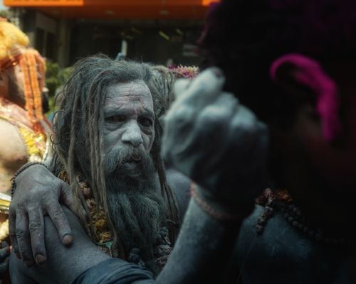 Free A close-up shot of a traditional Sadhu with ash-painted face at a cultural event. Stock Photo