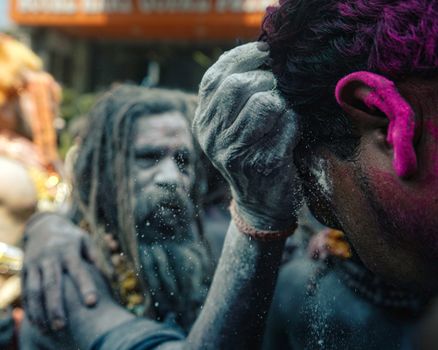 Dynamic scene capturing vibrant festival mood with colorful powders and energetic crowd.