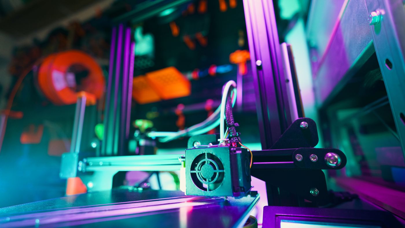 3D printer producing a part in a modern workshop