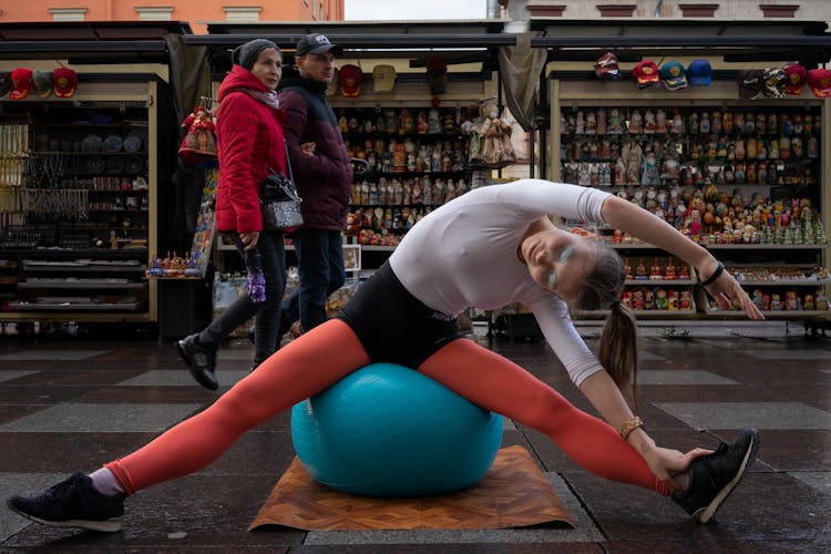 Woman Sitting On Blue Exercise Ball