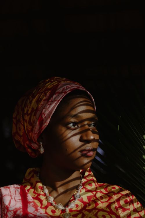 Free A striking portrait of a woman with patterned light and shadow. Stock Photo