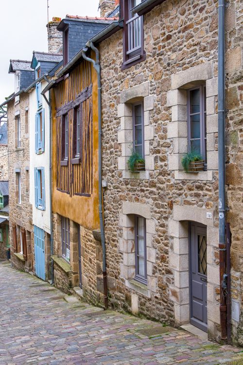 Free Historic stone buildings on a quaint street in Brittany, France offer a glimpse into medieval architecture. Stock Photo