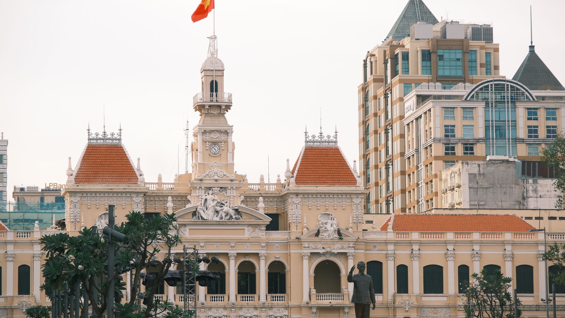 Majestic view of Saigon City Hall with Vietnamese flag in Ho Chi Minh City.