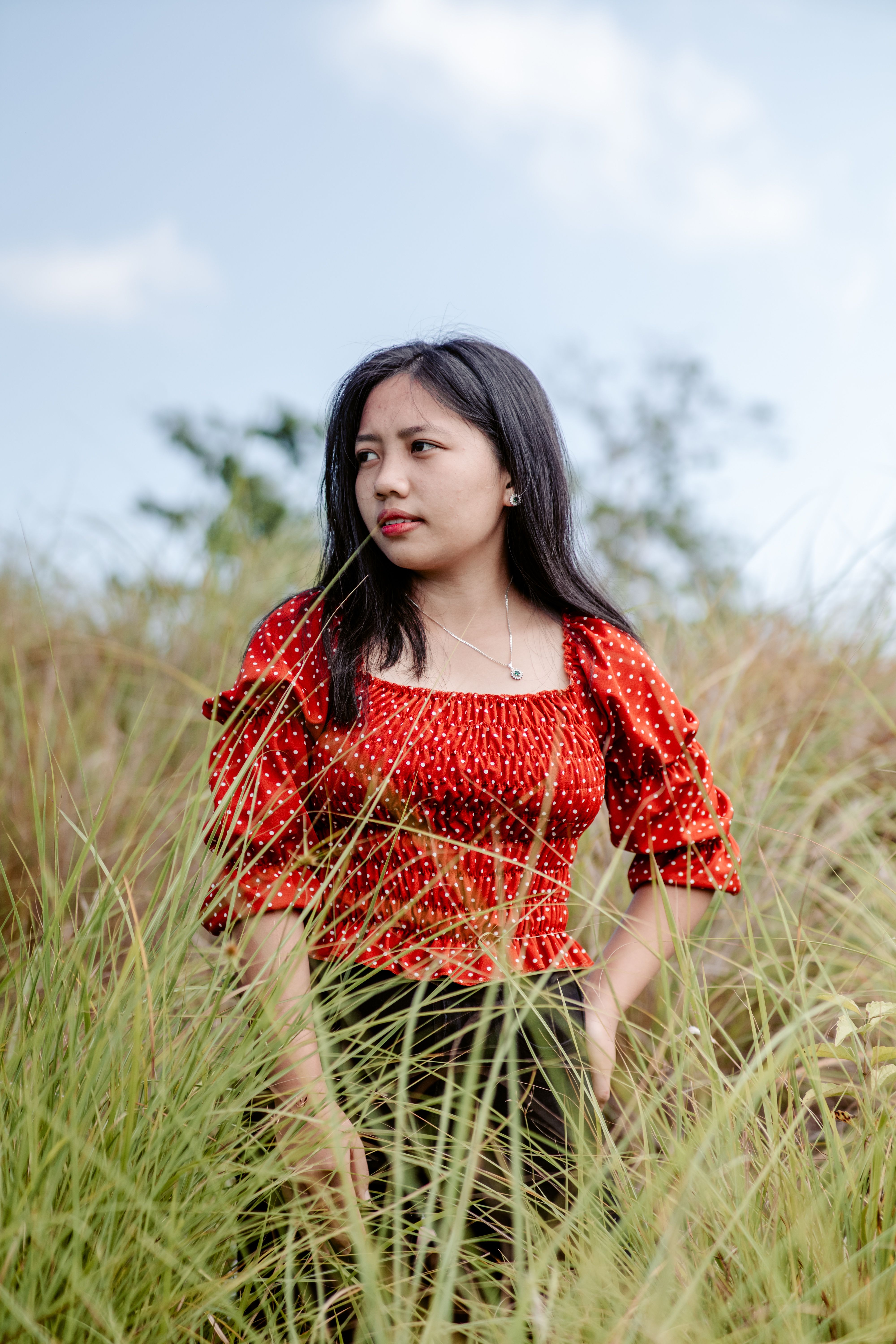 Young Woman in Red Dress in Grassy Field · Free Stock Photo