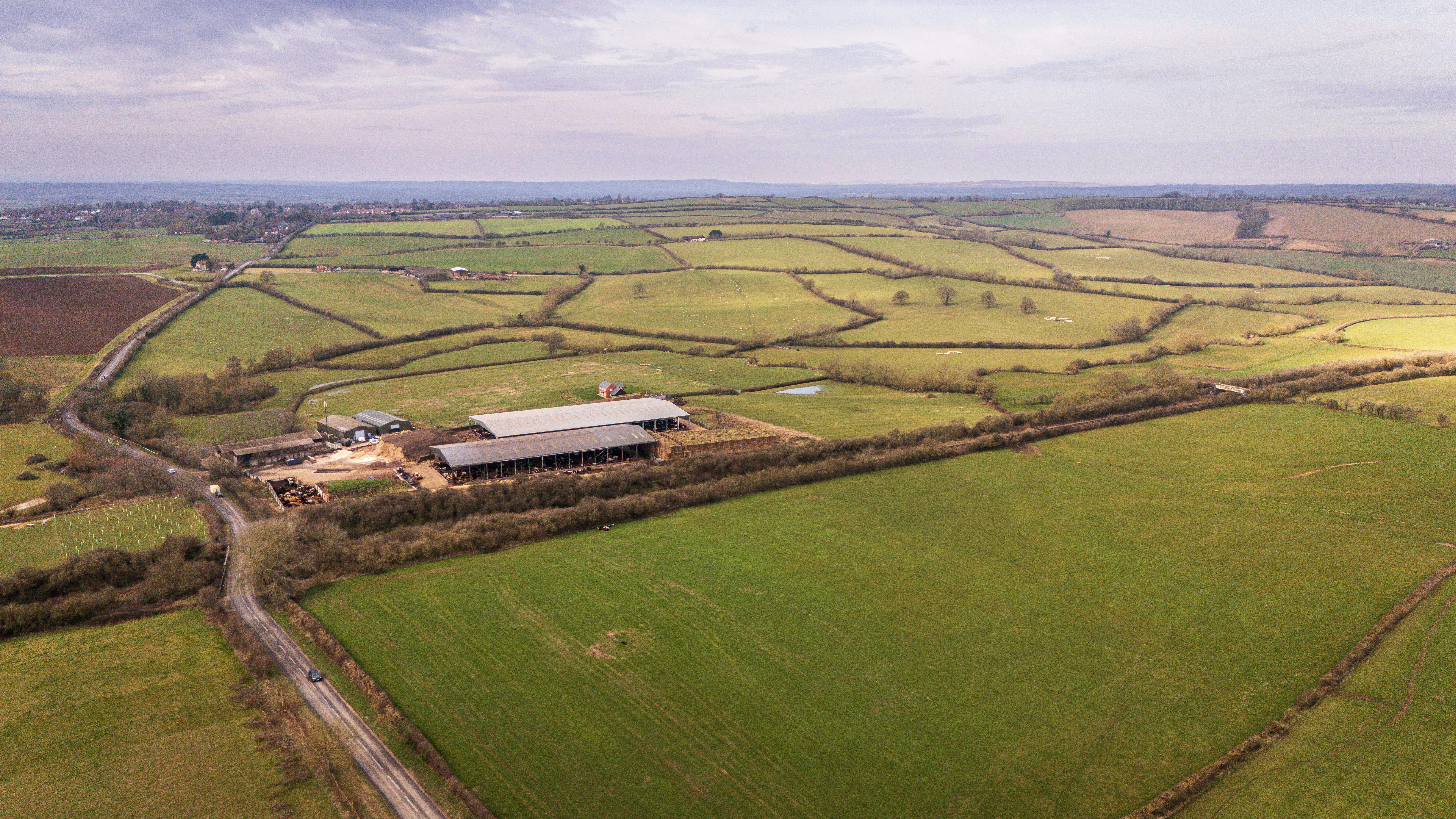 Expansive aerial view of a serene farm landscape in Buckinghamshire, England.