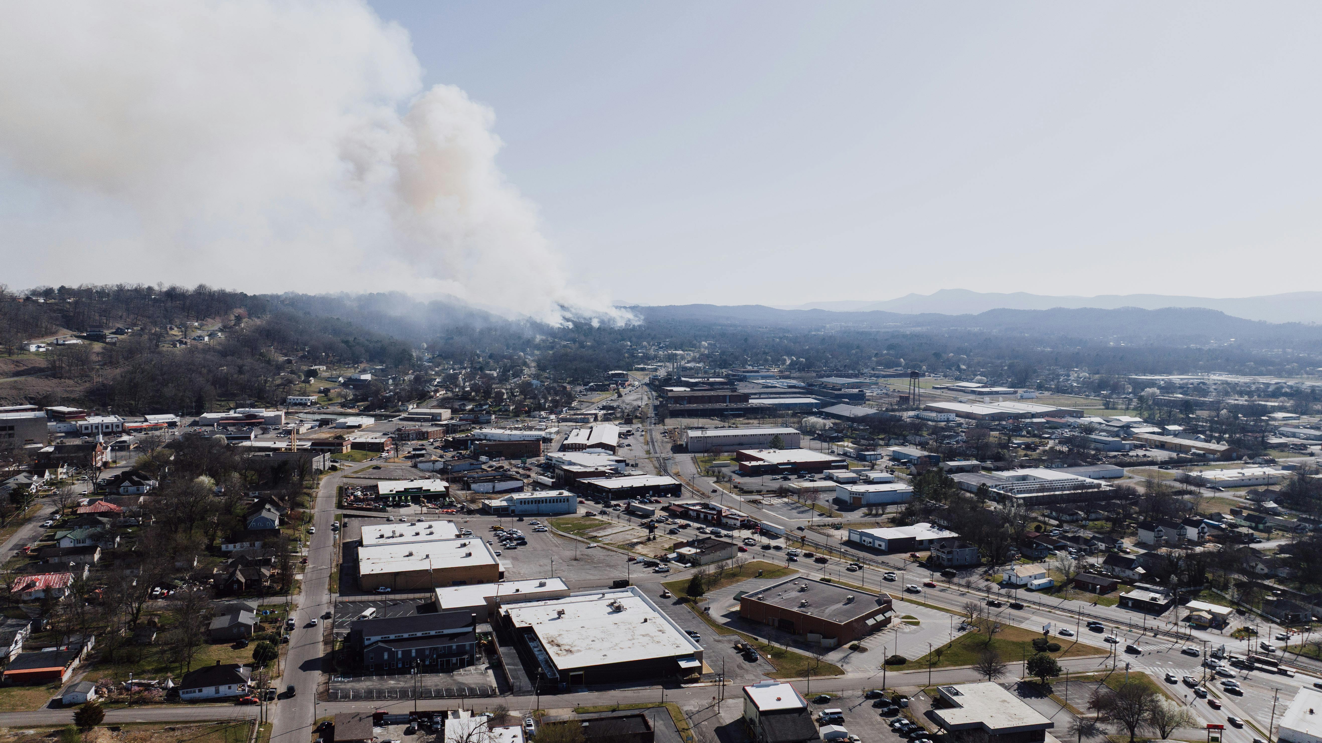 Smoke rising in a neighborhood after a house fire