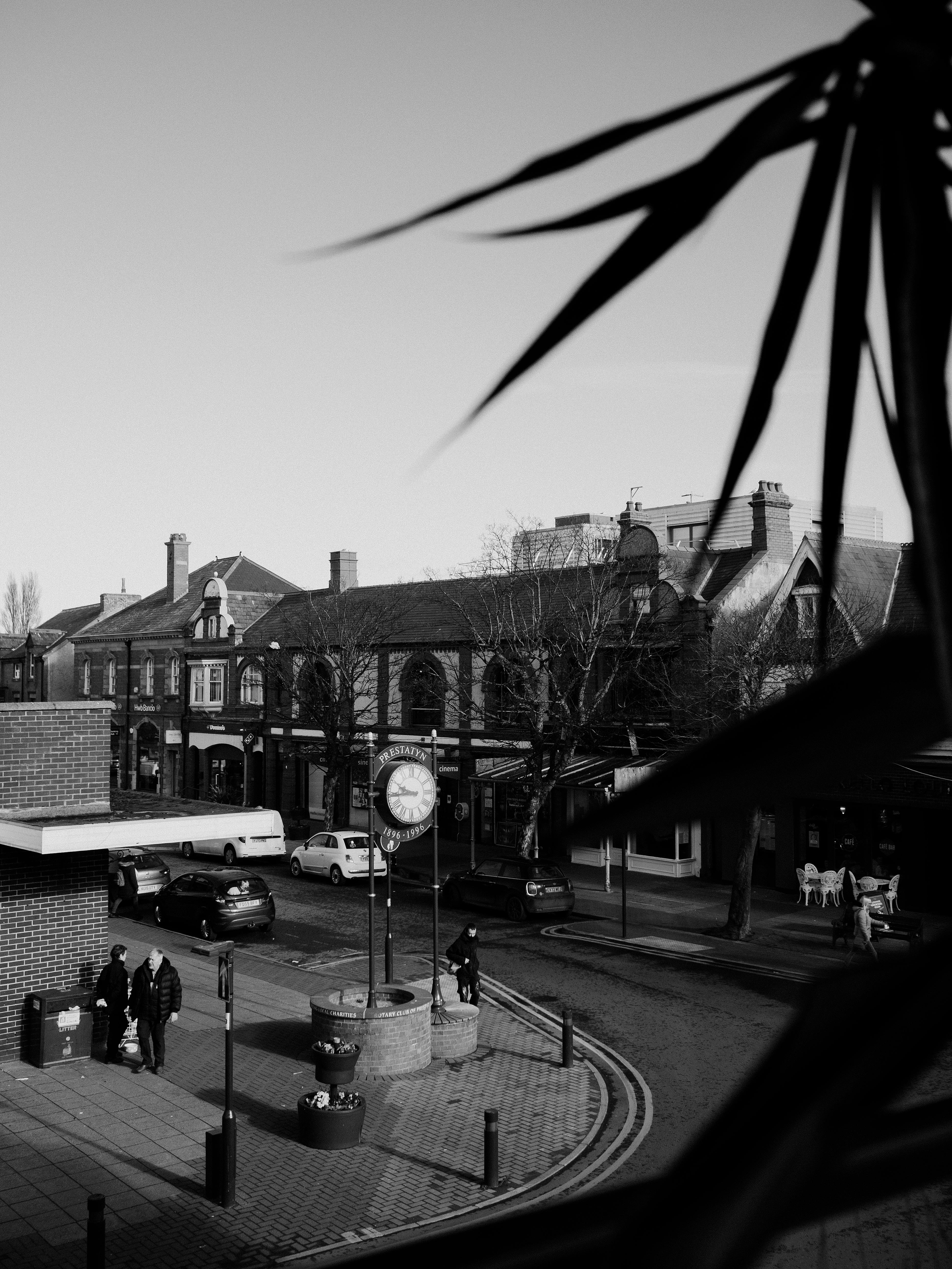 A classic black and white street scene in Prestatyn, capturing daily life and architecture.