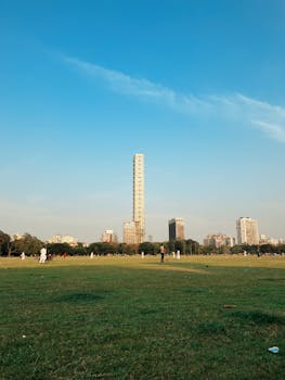 Vibrant skyline with The 42 skyscraper in Kolkata, captured on a sunny day with clear blue skies.