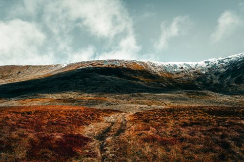 Free Breathtaking Scottish Highlands scene with autumn hues under a moody sky. Stock Photo