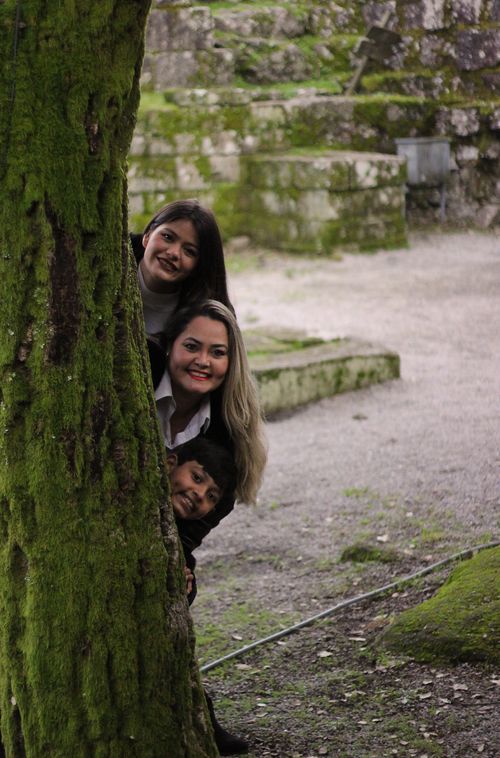 Free A family enjoying a playful moment at ancient ruins in Póvoa de Lanhoso, Portugal. Stock Photo