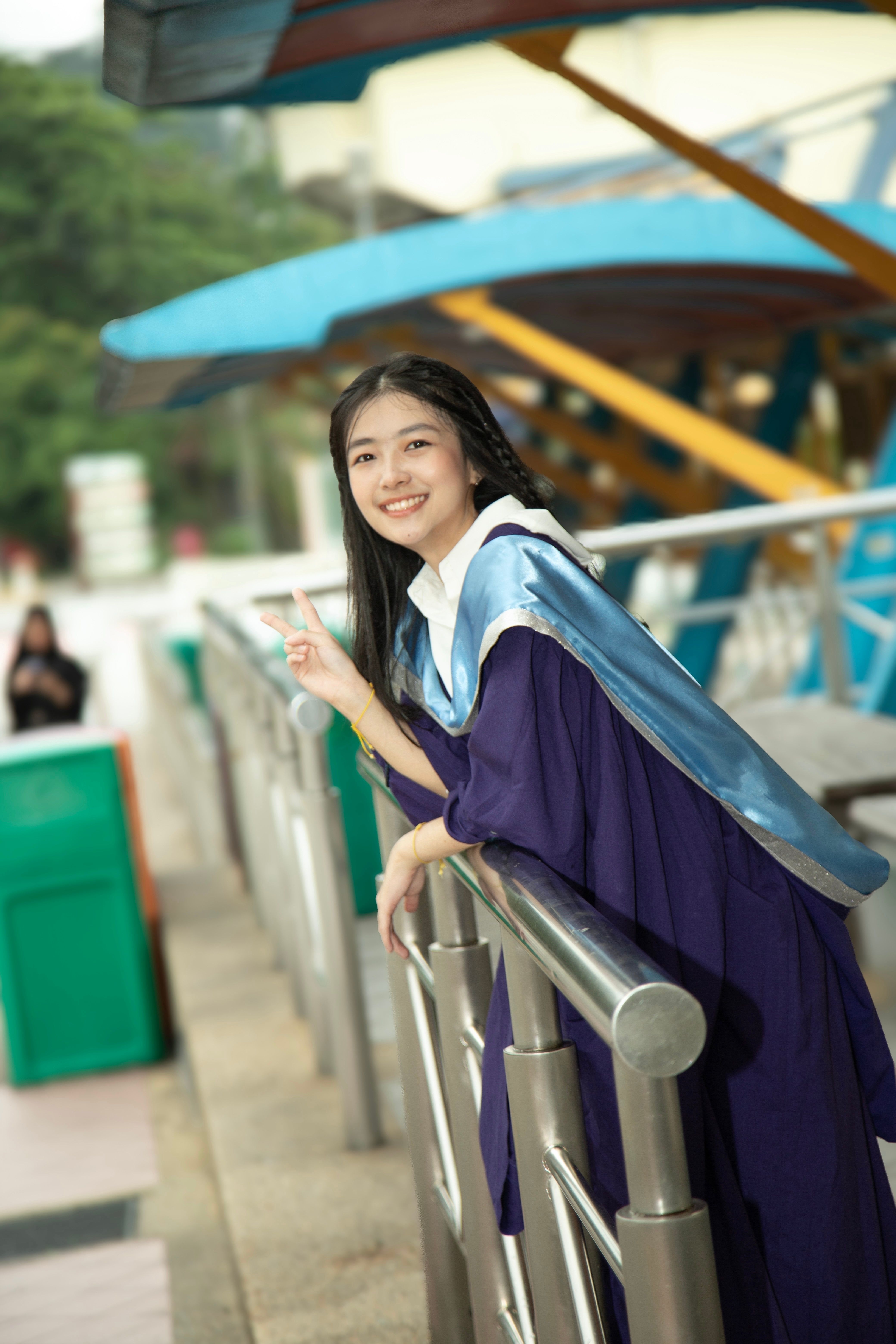 Young Graduate Posing Outdoors in Cap and Gown · Free Stock Photo