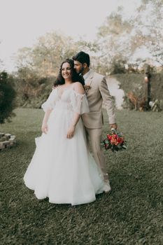 Charming portrait of a couple on their wedding day in a lush garden setting.
