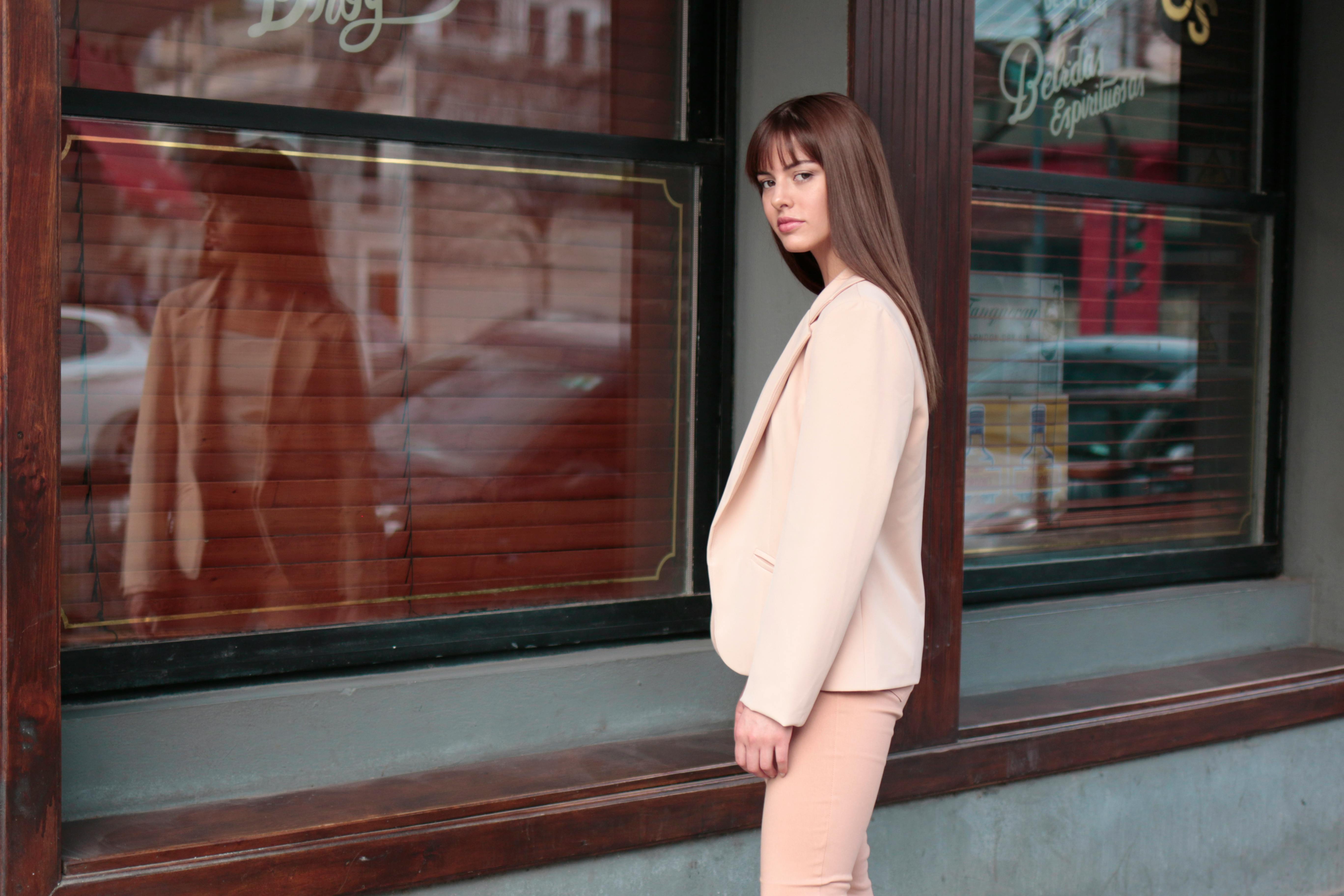 时尚模特在布宜诺斯艾利斯街头商店的橱窗前摆姿势