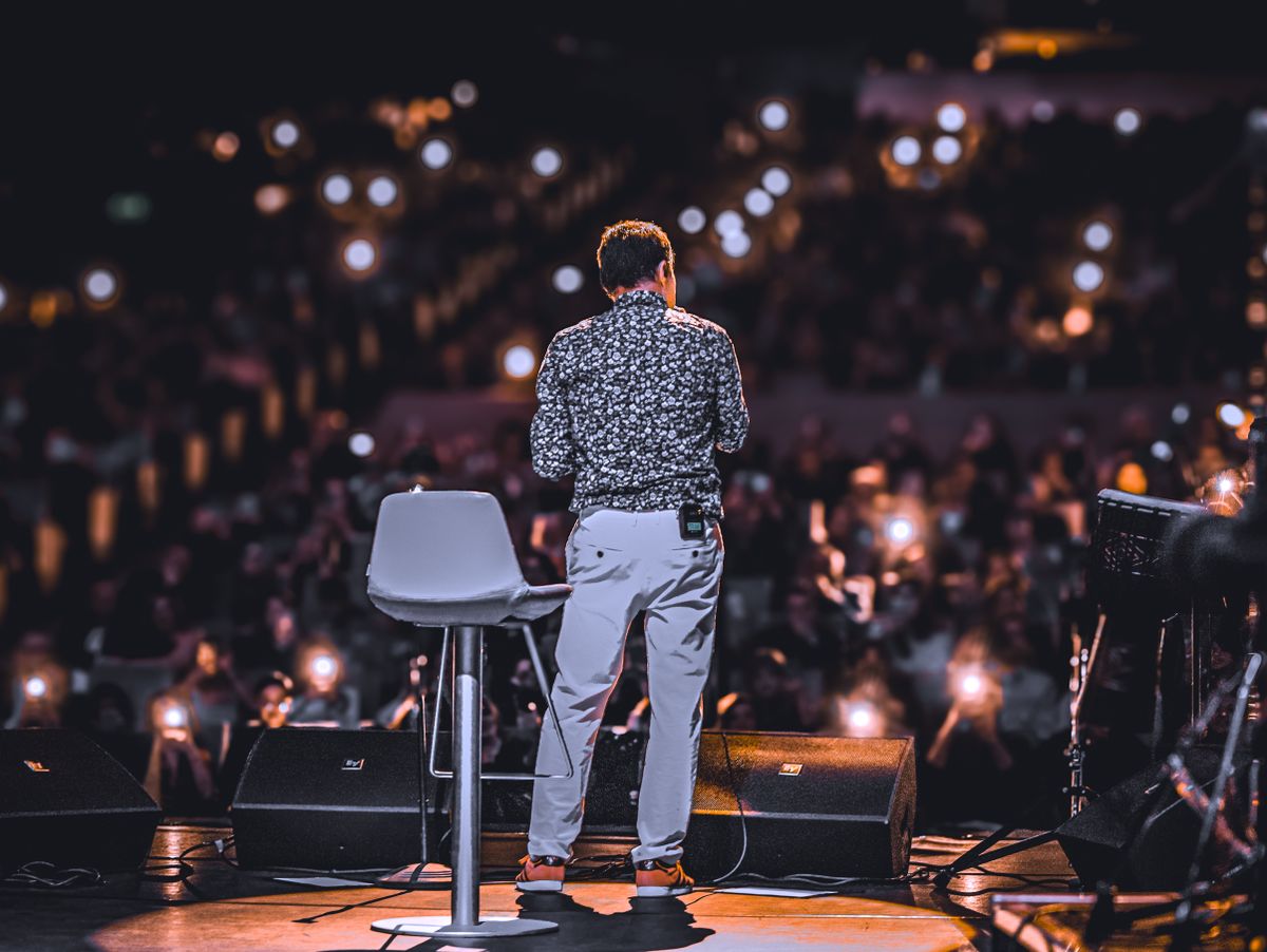 Speaker walking toward stage with audience lights