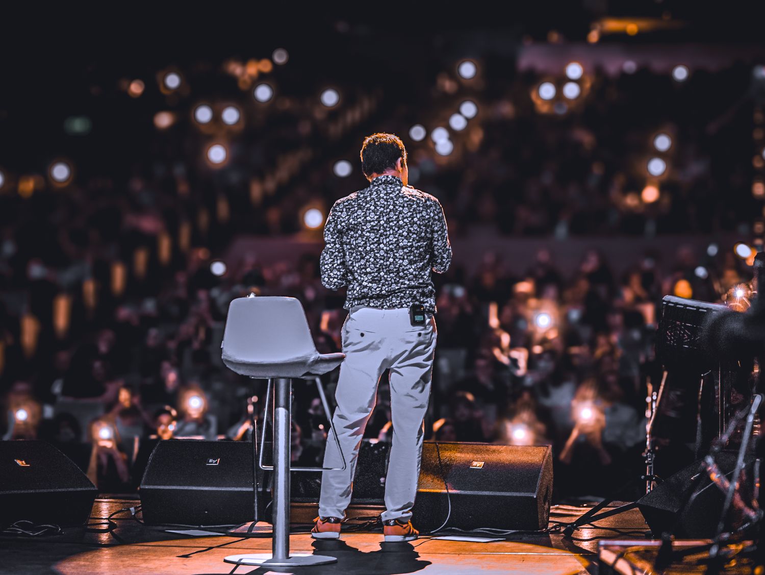 A speaker on stage in front of a full auditorium — Kerim Isazade on Pexels