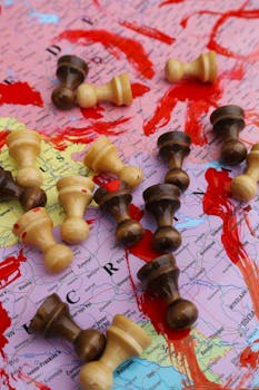 Photo by Alexandru-Cătălin Stoica Chess pieces on a world map highlight the strategic aspect of global conflicts.