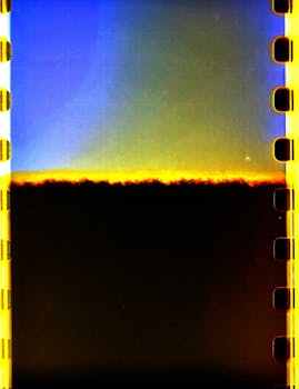 35mm film strip showcasing vibrant blue, yellow, and black colors with abstract textures.
