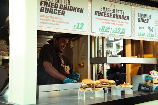 Street food vendor serves tasty burgers at a vibrant food market stall. Capturing the essence of urban cuisine.