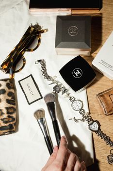 Luxury fashion and beauty flat lay with makeup and jewelry.