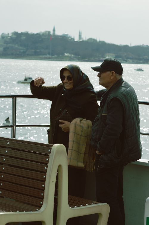 Free Elderly couple on a river ferry, enjoying the view. Peaceful and serene scene. Stock Photo
