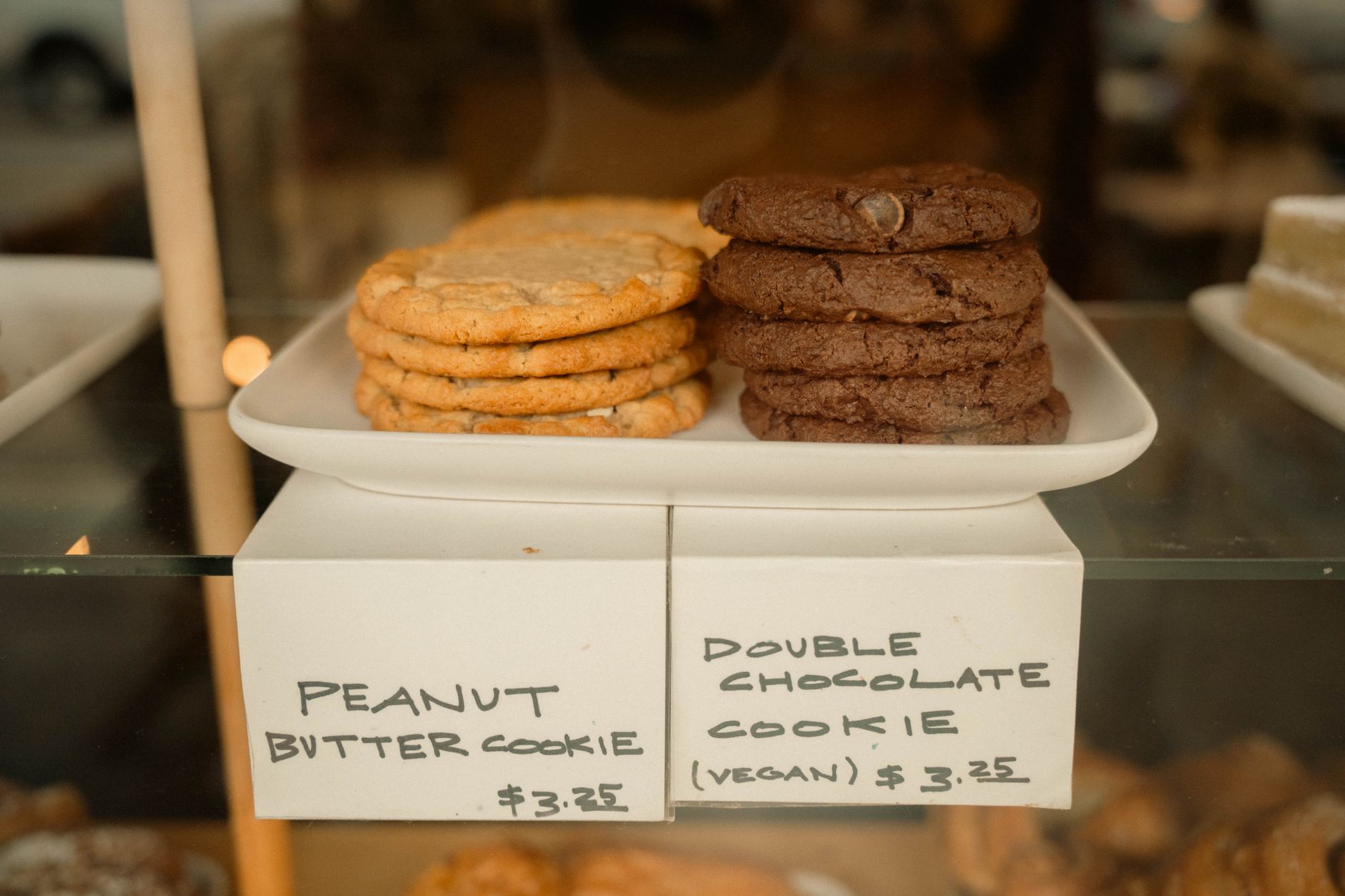 Decadent Chocolate Tahini Cookies in One Bowl Display of peanut butter and vegan chocolate cookies in a bakery shop.