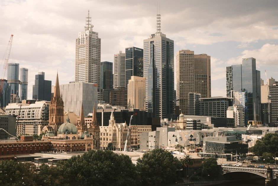Stunning aerial view of Melbourne city skyline, showcasing modern skyscrapers and historic architecture.