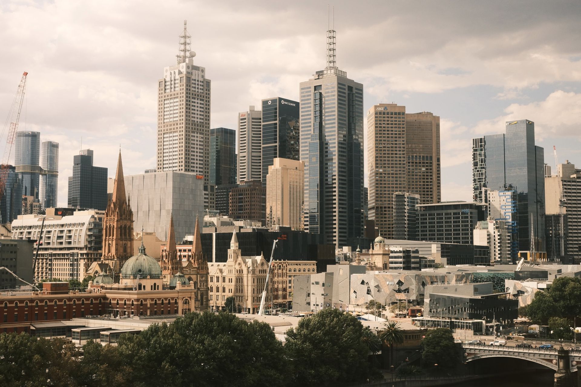 Stunning aerial view of Melbourne city skyline, showcasing modern skyscrapers and historic architecture.