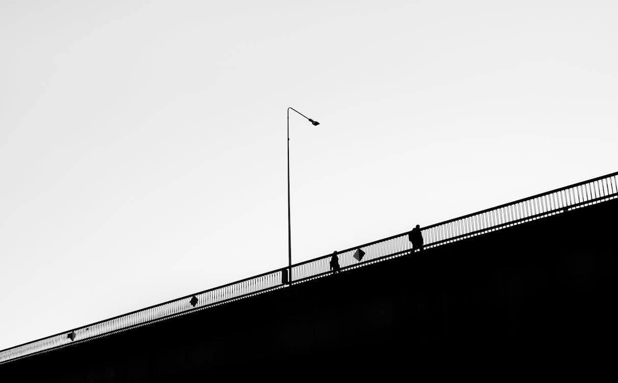 Free Silhouette of Man Near Railing Stock Photo