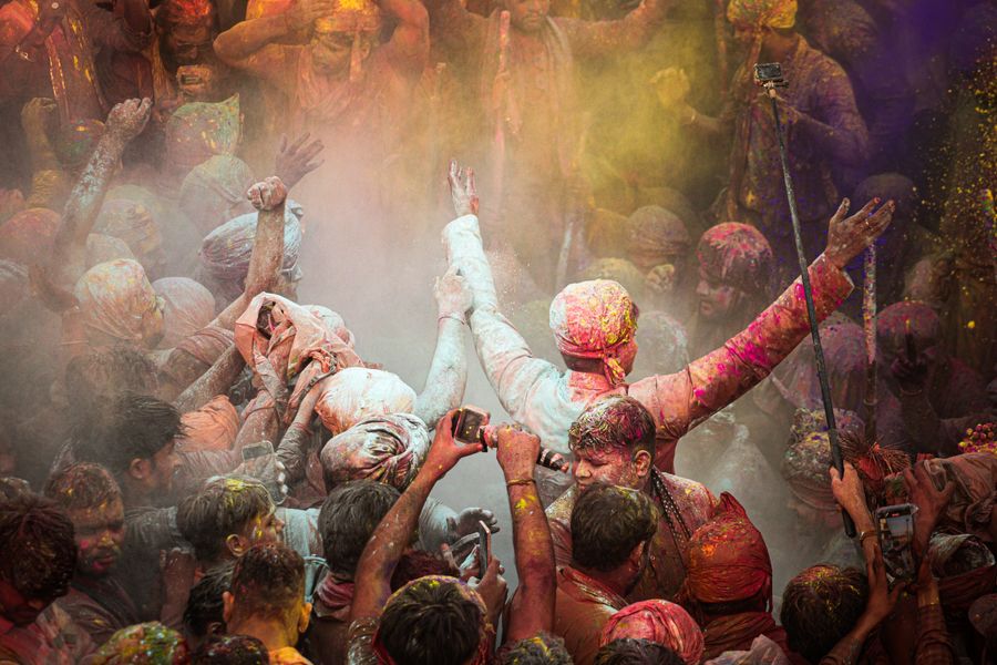 Joyful celebration of Holi festival in Barsana, India with colorful powders.