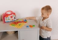 Child Playing with Colorful Educational Toy