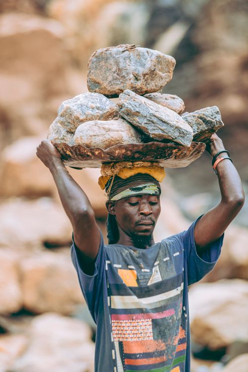 Workers Carrying Rocks Laborer Carrying Heavy Rocks Outdoors · Free Stock Photo