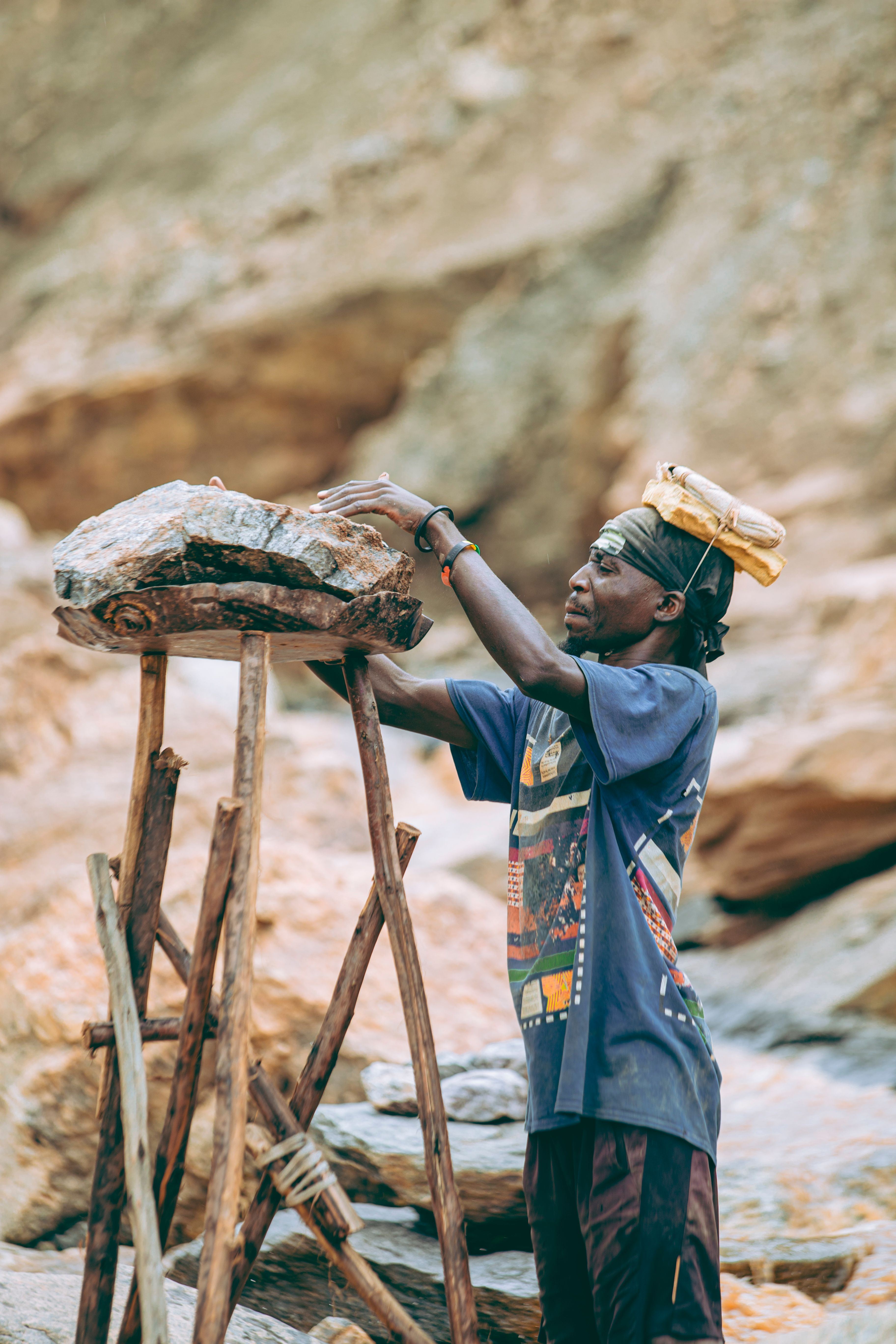 Candid Shot of Worker Balancing Rocks Outdoors · Free Stock Photo