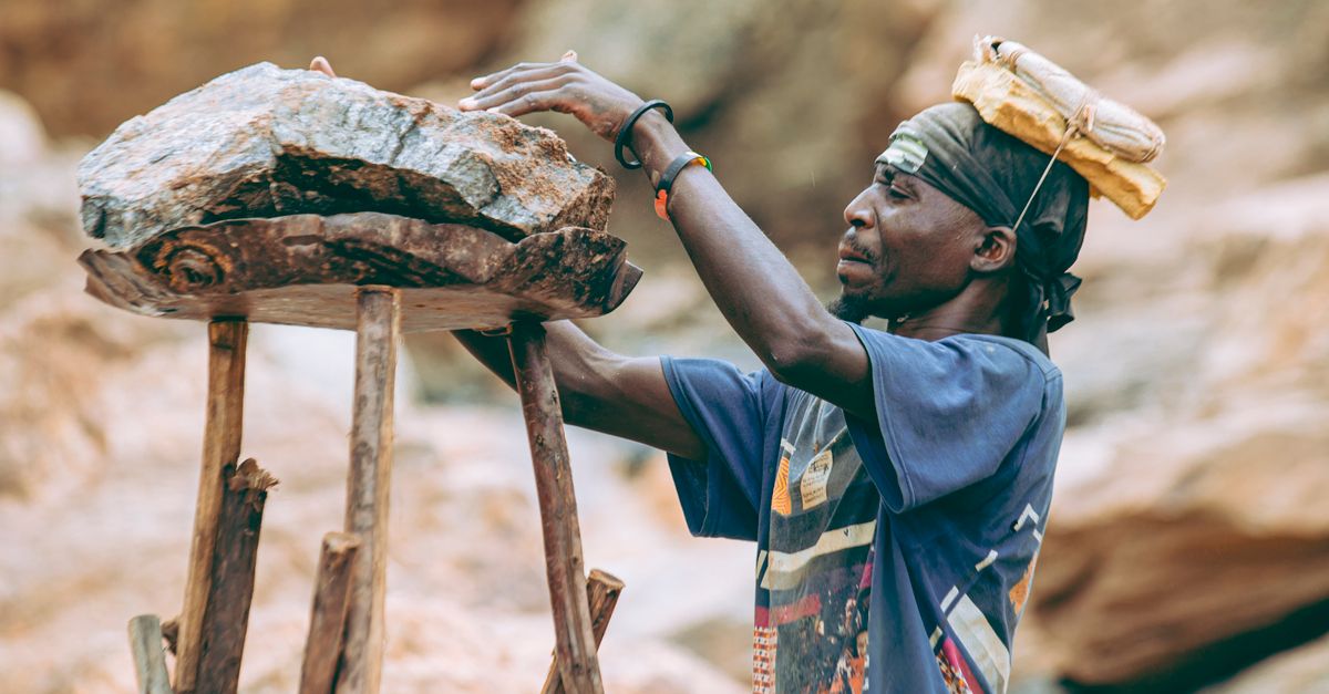 Workers Carrying Rocks Candid Shot of Worker Balancing Rocks Outdoors · Free Stock Photo