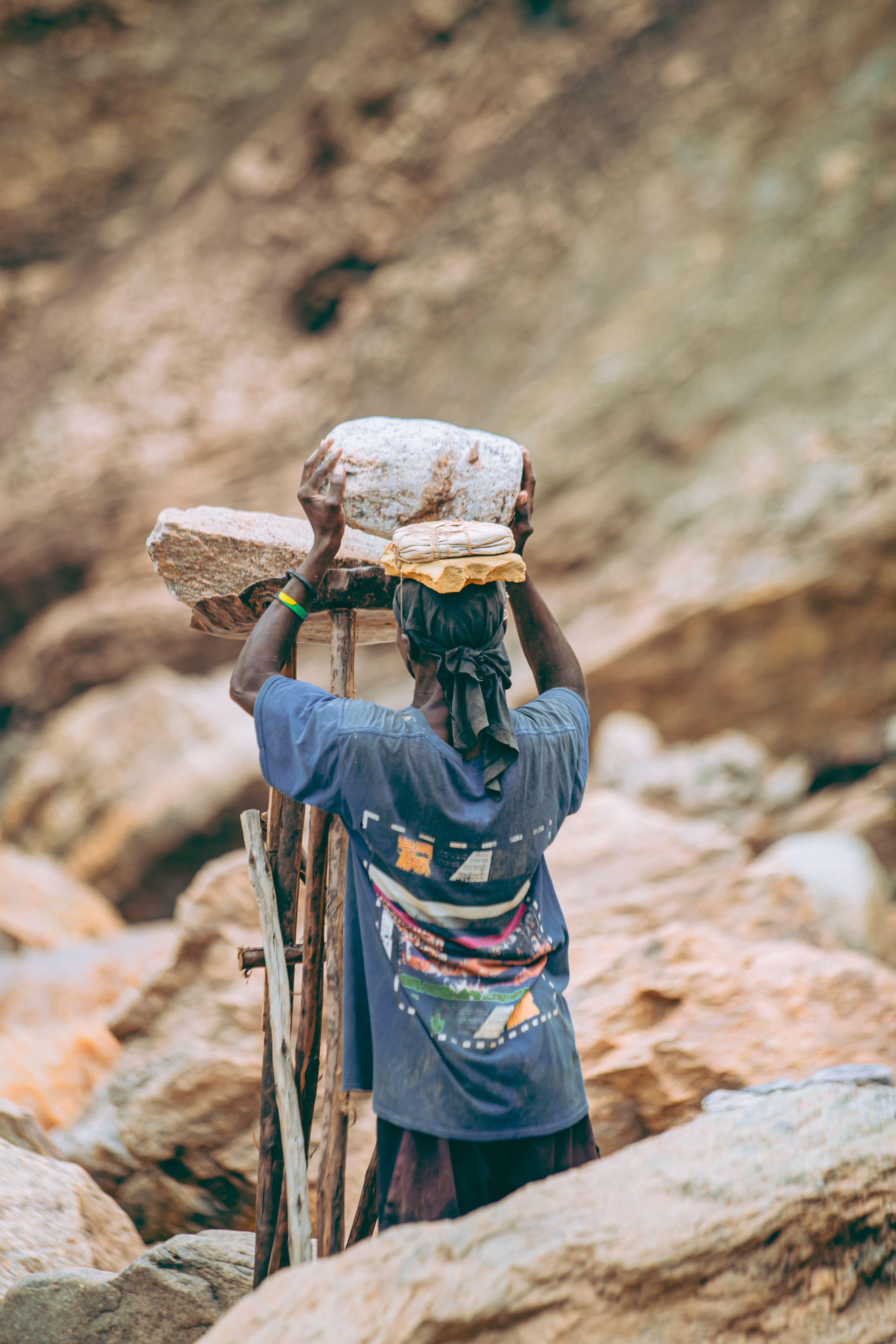 Worker Balancing Rocks in Quarry Landscape · Free Stock Photo