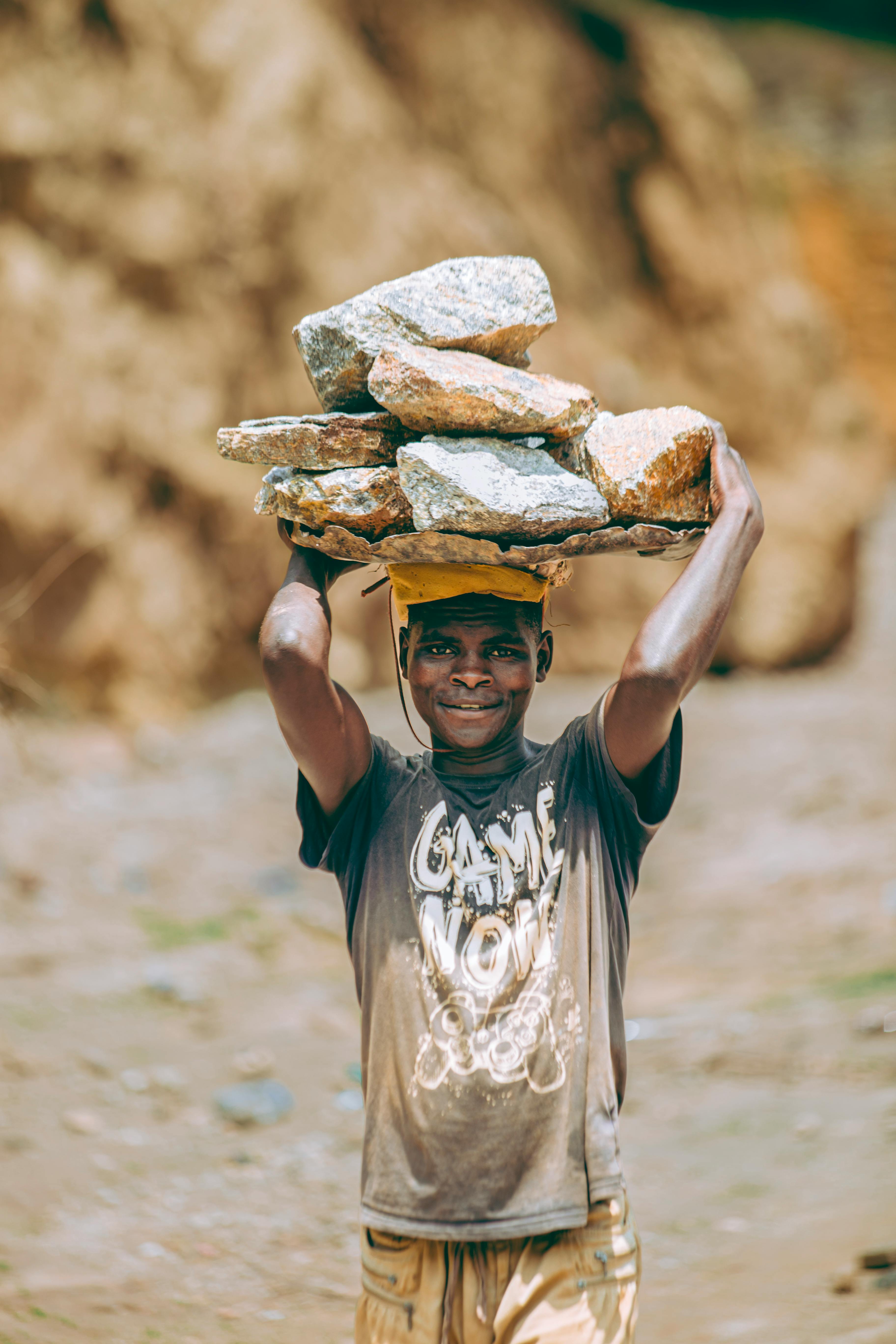 Worker Carrying Rocks with Determination · Free Stock Photo