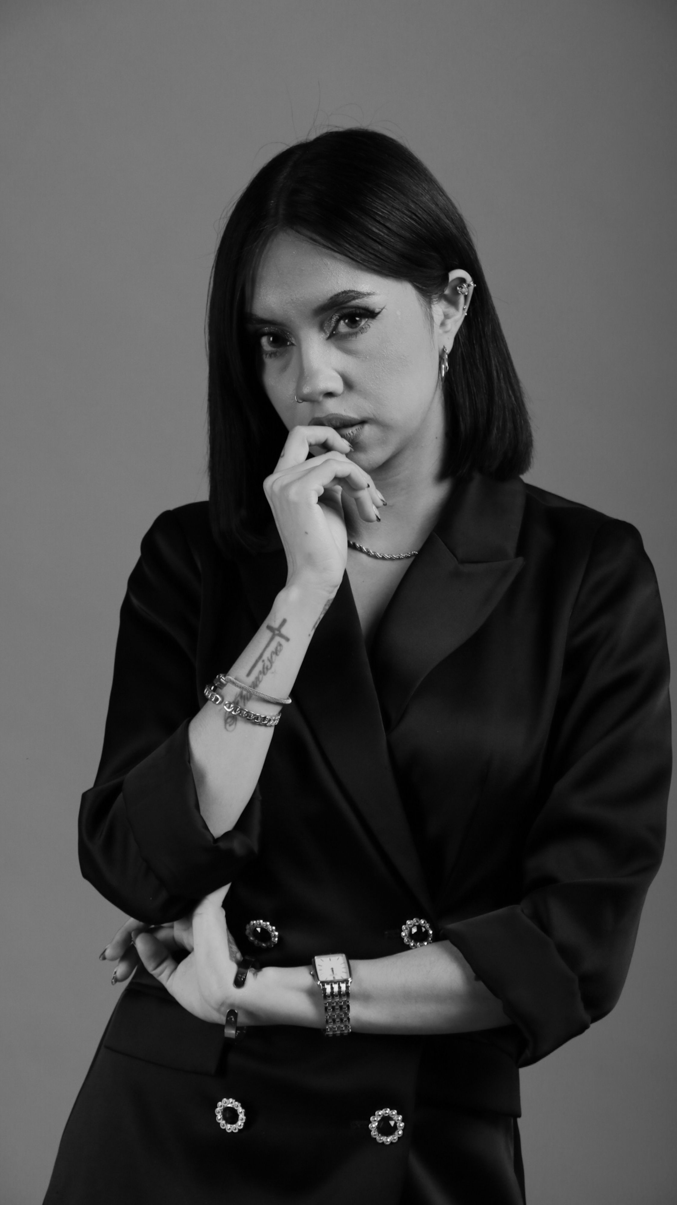 Stylish woman posing in a black and white portrait, showcasing elegance and sophistication.