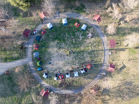 Aerial photo of a circular tent setup in a park in Kahramanmaraş, Türkiye, during daylight.