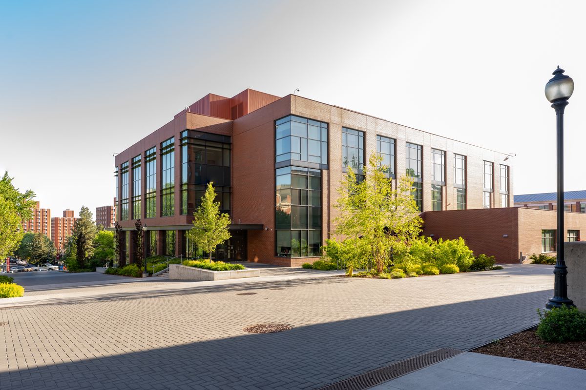 Modern university campus building with glass architecture and walkways