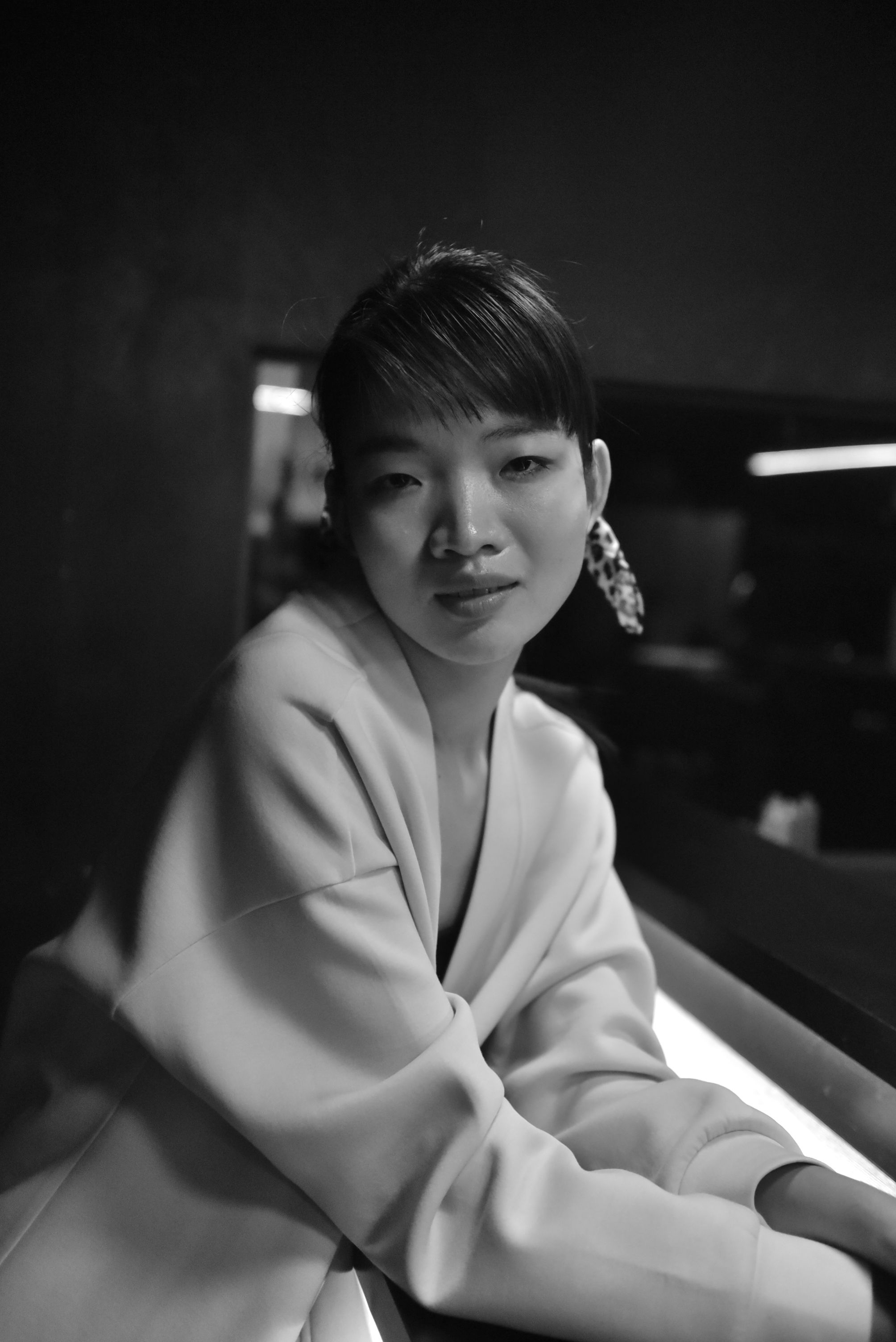 Stylish black and white portrait of an adult woman indoors.