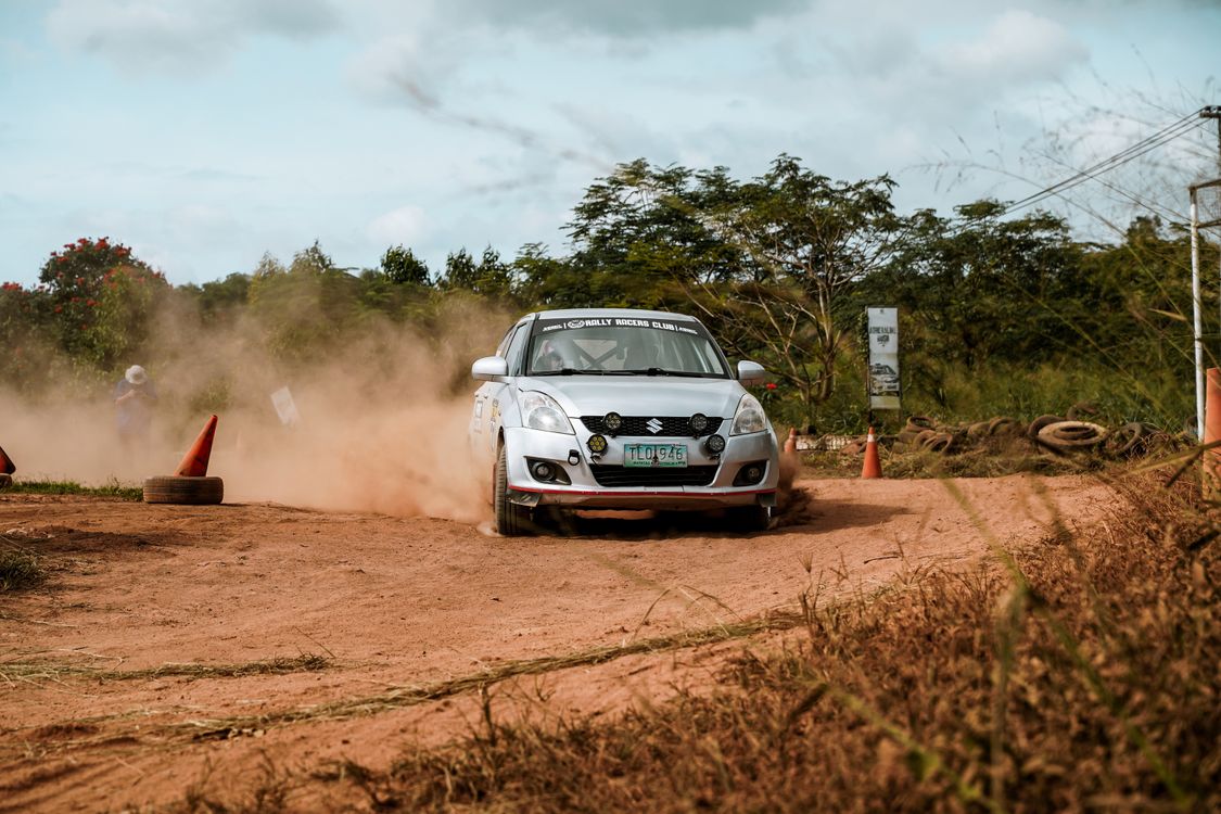 Dynamic Car Rally Action on Dirt Track · Free Stock Photo