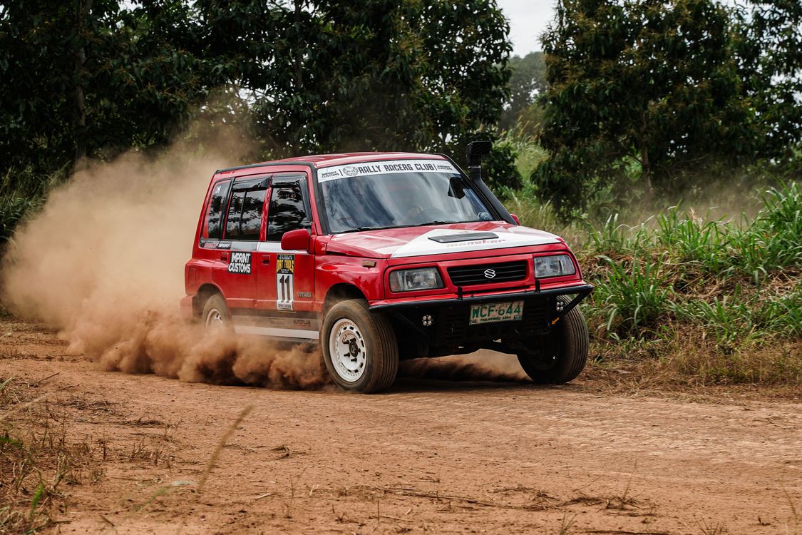 Dust Rally Road Red SUV Kicking Up Dust on Dirt Rally Track · Free Stock Photo