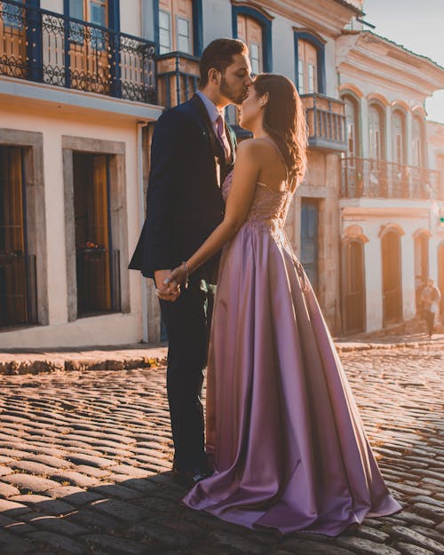 Free Man Kissing Woman's Forehead in the Middle of the Street Stock Photo