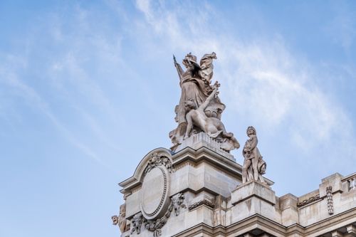 Free Intricate details of a sculpture at the Petit Palais against a clear sky in Paris, France. Stock Photo