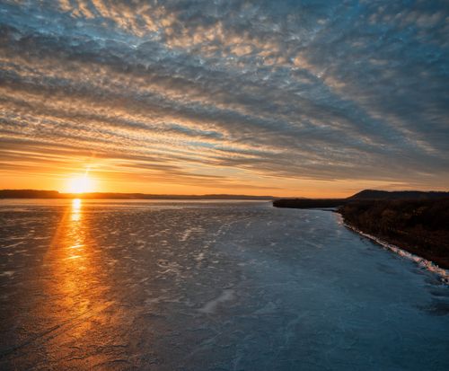 Free Beautiful winter sunset over a frozen lake in Pepin, Wisconsin, with vibrant skies. Stock Photo