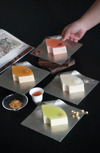 Artistic arrangement of colorful jelly and mousse cakes, perfect for gourmet cuisine enthusiasts.